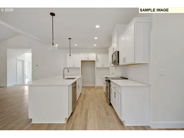 a kitchen with stainless steel appliances granite countertop a sink a stove and a refrigerator