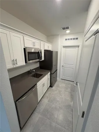 a kitchen with a refrigerator and a sink