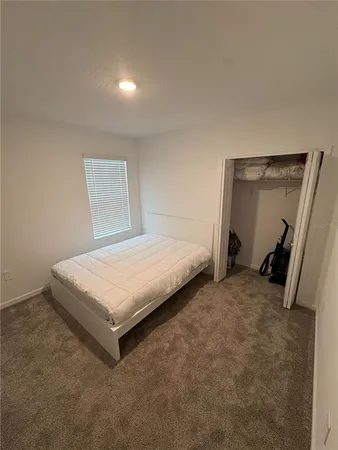 a bedroom with a bed and a mirror