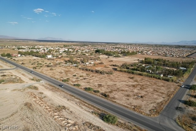 Aerial view of sparsely populated area featuring a mountainous background and a desert landscape