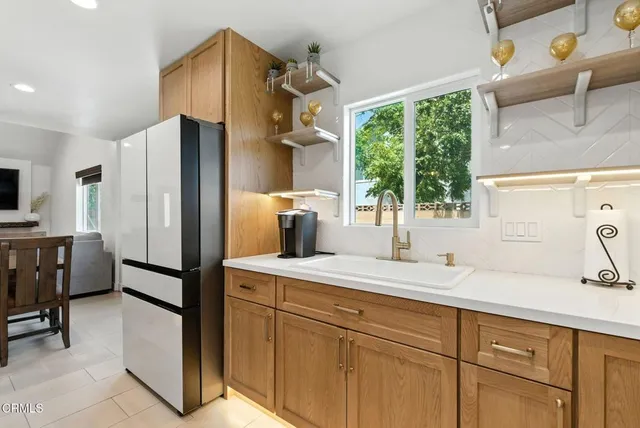 a kitchen with a refrigerator and a sink