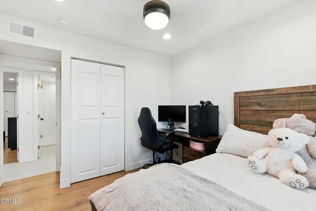 a bedroom with a bed and a chair