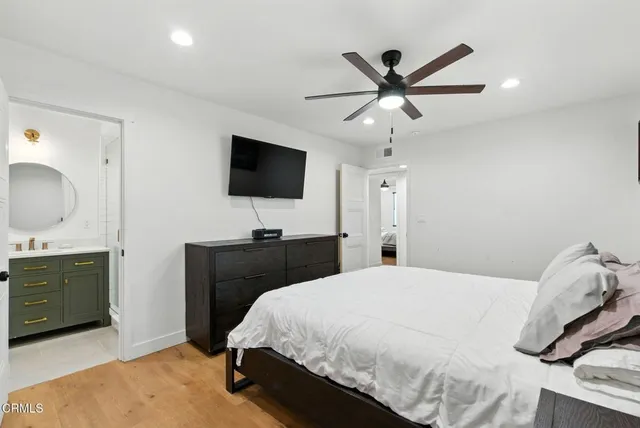 a bedroom with a bed and a flat screen tv