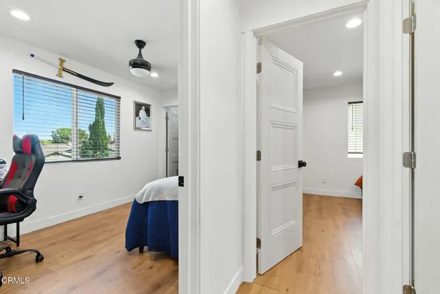 a view of hallway with furniture and a window