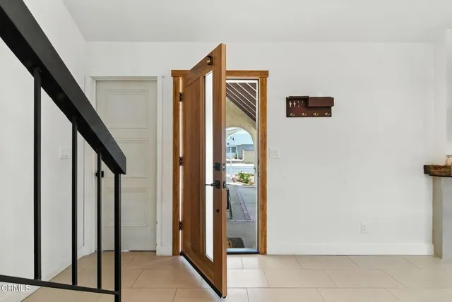 a view of hallway with stairs and wooden floor