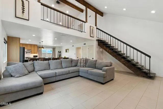 a living room with furniture and a ceiling fan
