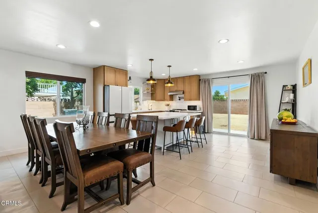 a dining room with furniture and a floor to ceiling window