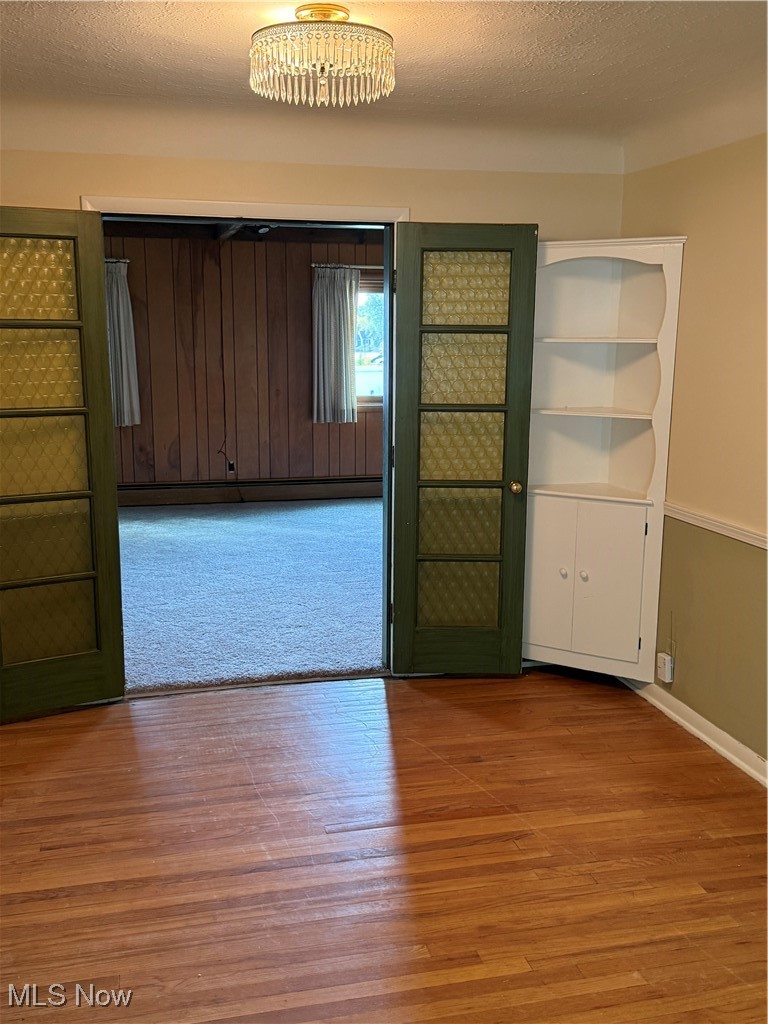 1284 Haverston Road Lyndhurst, OH 44124 - Photo 15 of 43 Unfurnished room featuring a textured ceiling, hardwood / wood-style floors, and baseboard heating