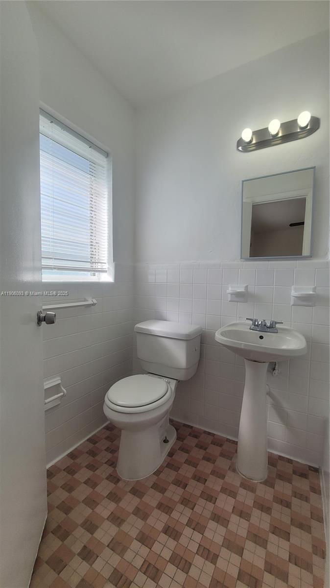 2601 Southwest 22nd Avenue, Unit 9 Miami, FL 33133 - Photo 13 of 15 a bathroom with a sink toilet and mirror