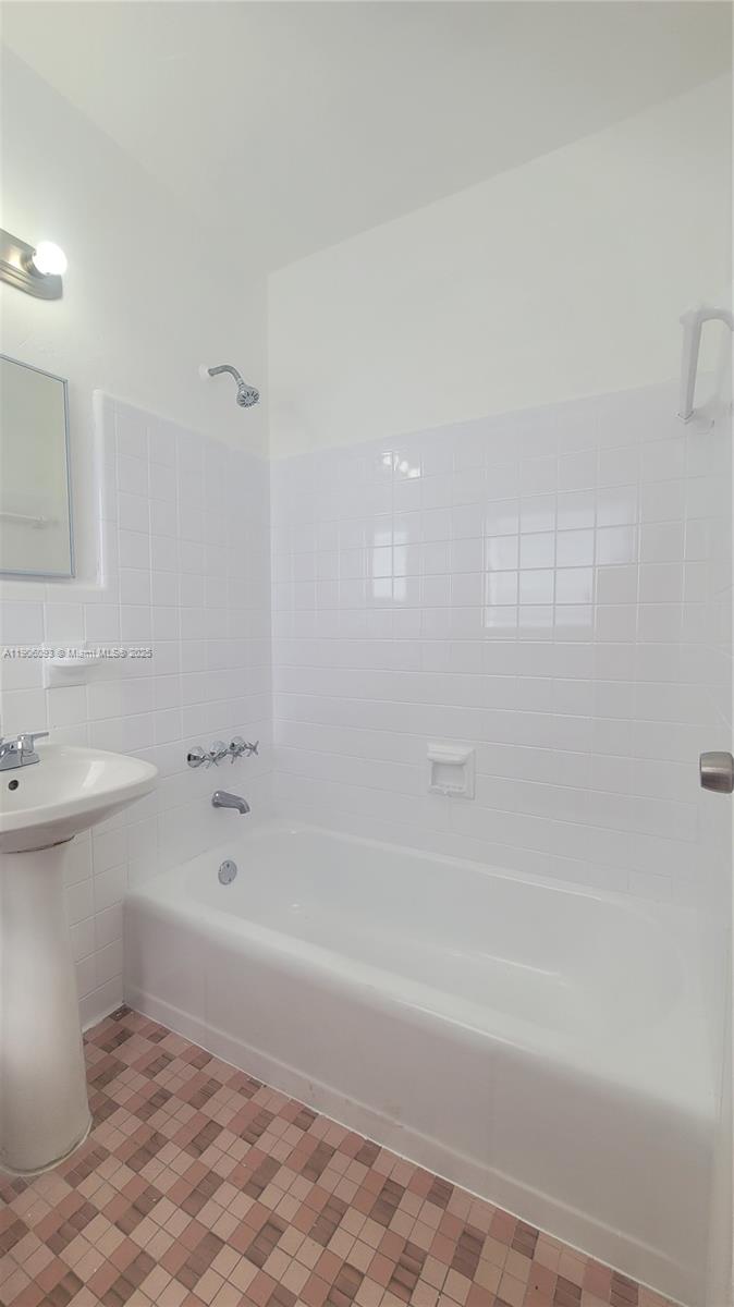 2601 Southwest 22nd Avenue, Unit 9 Miami, FL 33133 - Photo 14 of 15 a bathroom with a sink a toilet and shower