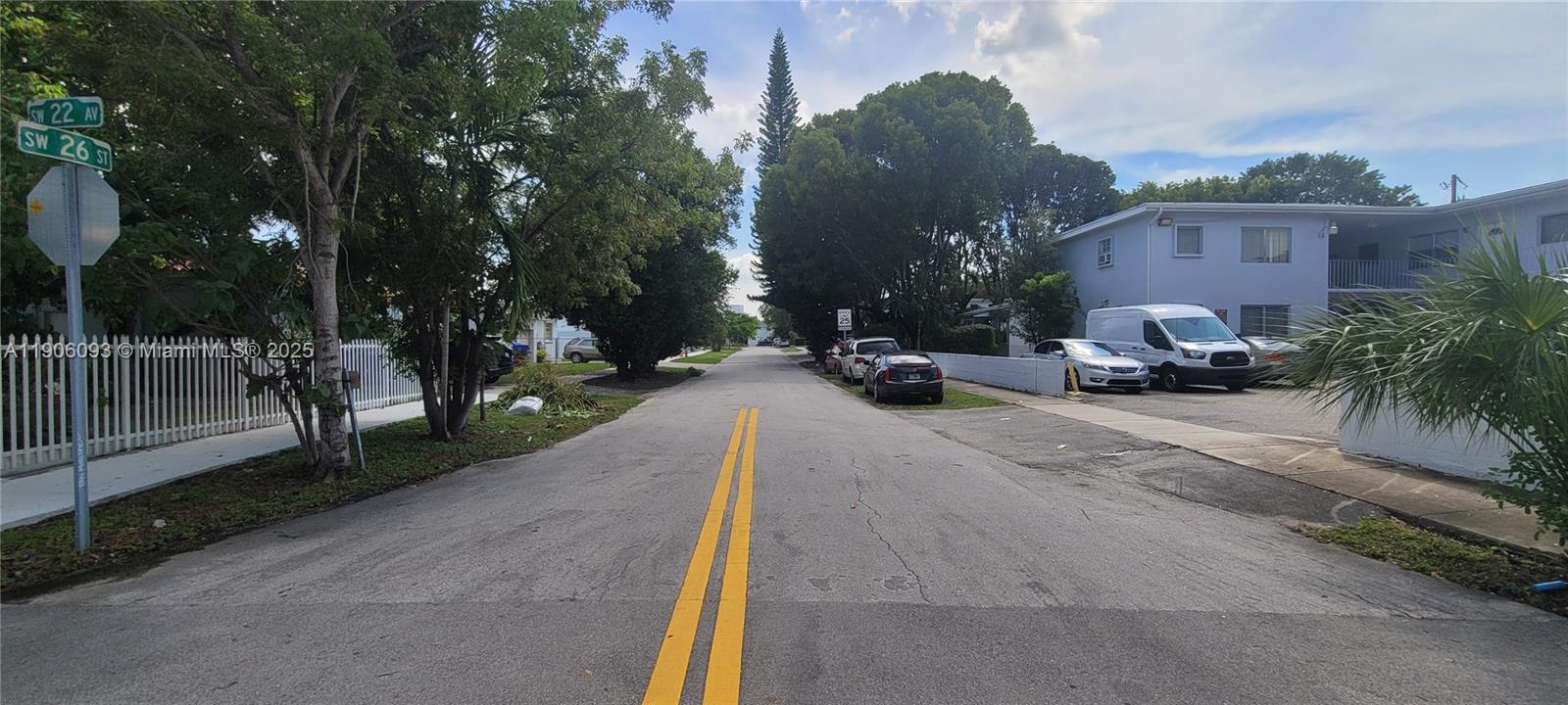 2601 Southwest 22nd Avenue, Unit 9 Miami, FL 33133 - Photo 15 of 15 a view of a patio with a table and chairs under an umbrella with large trees