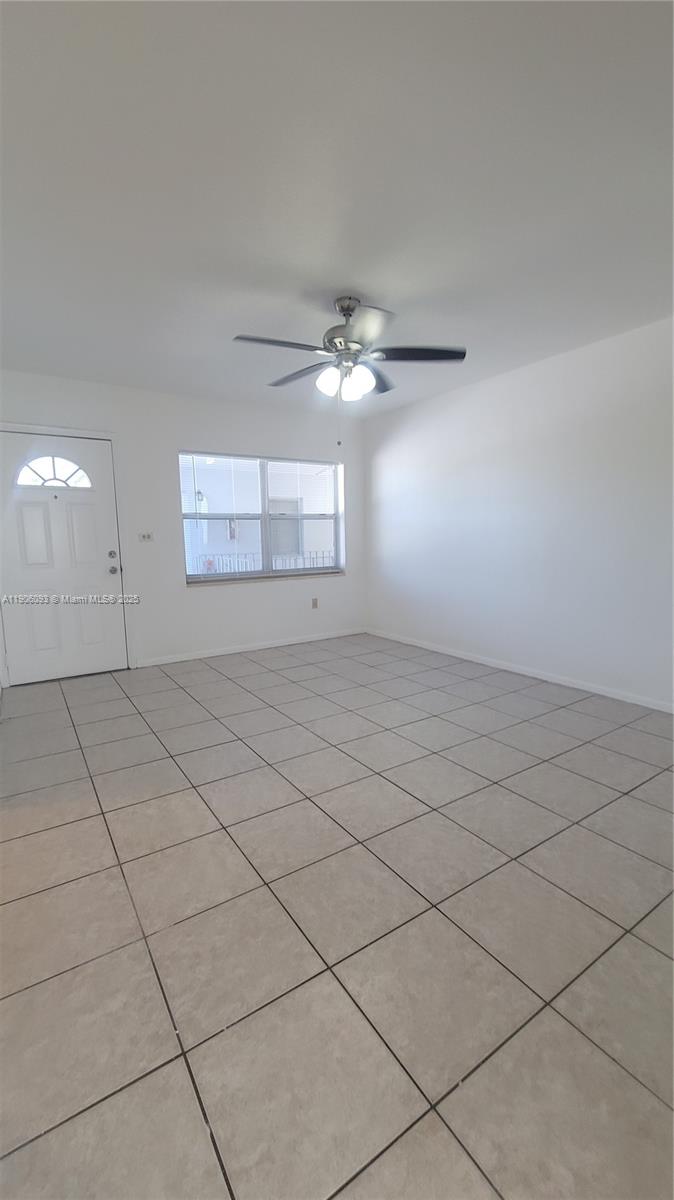 2601 Southwest 22nd Avenue, Unit 9 Miami, FL 33133 - Photo 4 of 15 an empty room with windows and ceiling fan