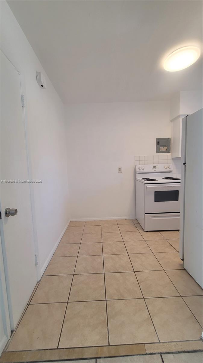 2601 Southwest 22nd Avenue, Unit 9 Miami, FL 33133 - Photo 5 of 15 a kitchen with a stove a sink and a refrigerator