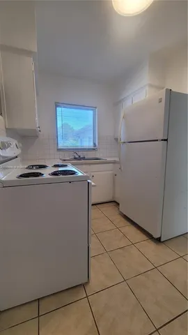a kitchen with stainless steel appliances granite countertop a refrigerator sink a stove and dishwasher