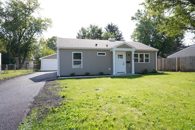 a view of a house with a yard and garage
