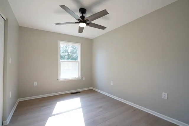 wooden floor in an empty room with a window