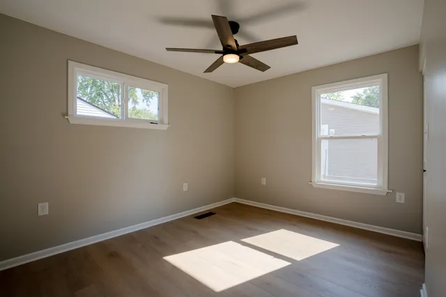 wooden floor in an empty room with a window