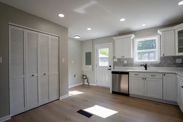 a kitchen with granite countertop a sink cabinets and window