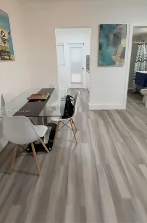 a view of a workspace with furniture and wooden floor