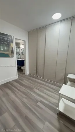 a view of a room that has a bed and a mirror in it