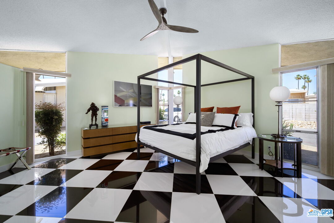 37800 Da Vall Drive, Unit 9 Rancho Mirage, CA 92270 - Photo 17 of 24 a bedroom with a bed and wooden floor