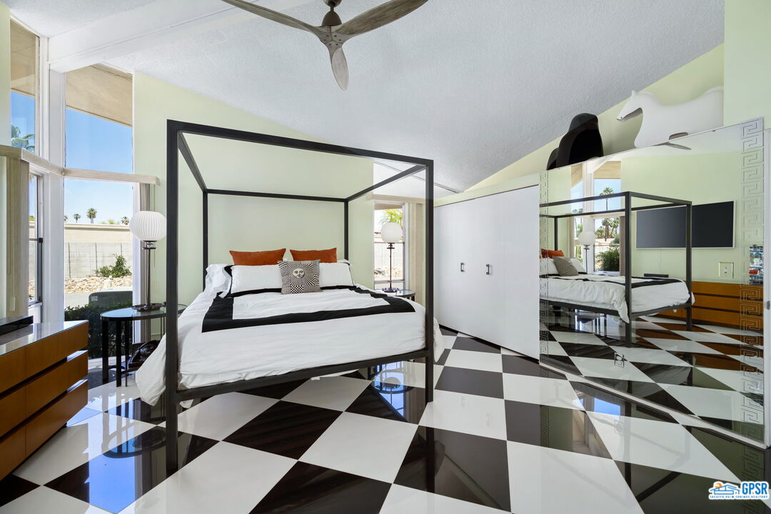 37800 Da Vall Drive, Unit 9 Rancho Mirage, CA 92270 - Photo 18 of 24 a bedroom with a bed and wooden floor
