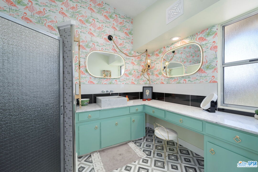 37800 Da Vall Drive, Unit 9 Rancho Mirage, CA 92270 - Photo 19 of 24 a bathroom with a double vanity sink and a mirror