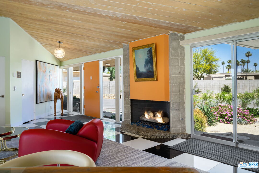 37800 Da Vall Drive, Unit 9 Rancho Mirage, CA 92270 - Photo 5 of 24 a living room with furniture and a fireplace