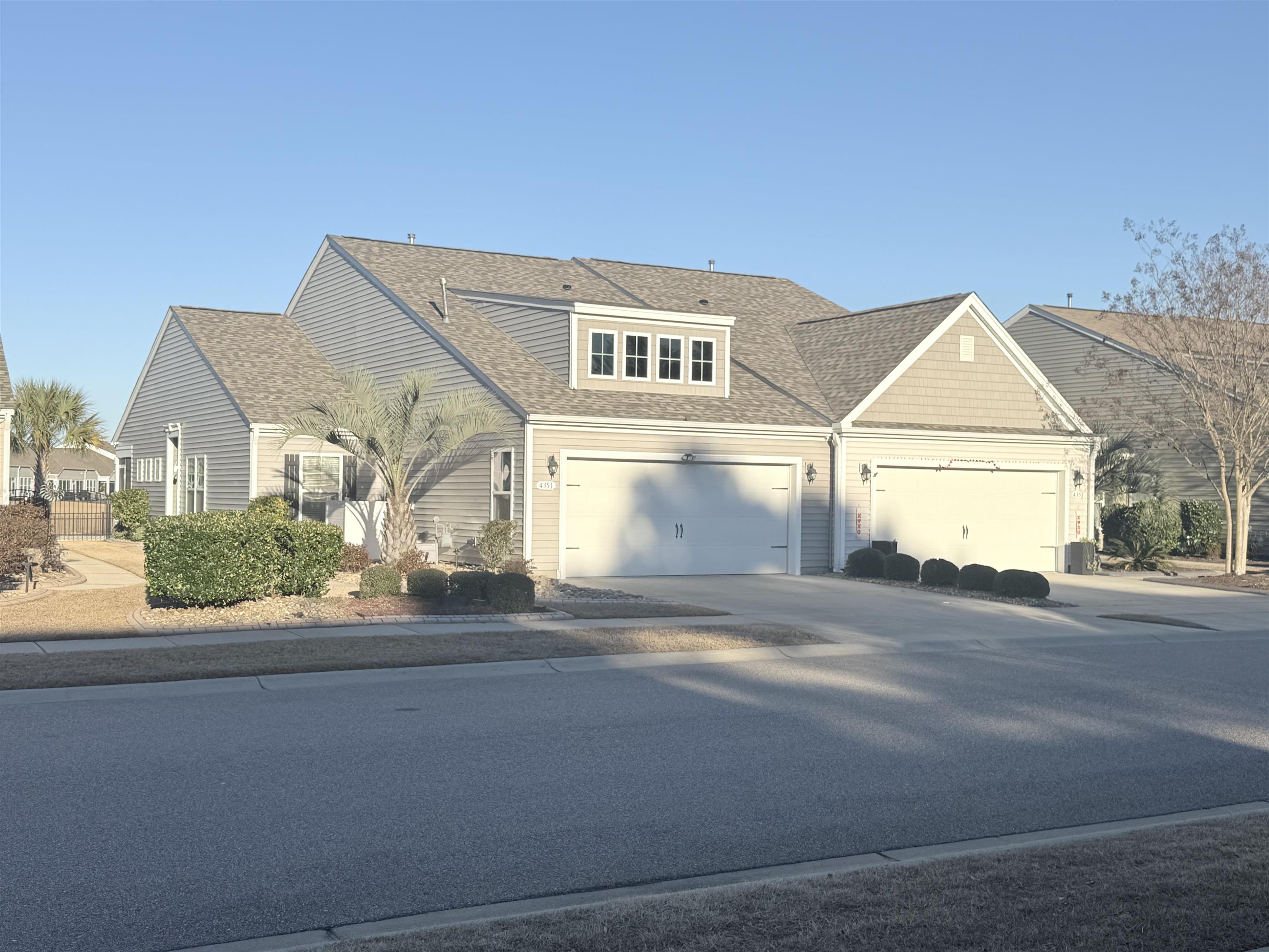 View of property exterior with a shingled roof and a central AC unit