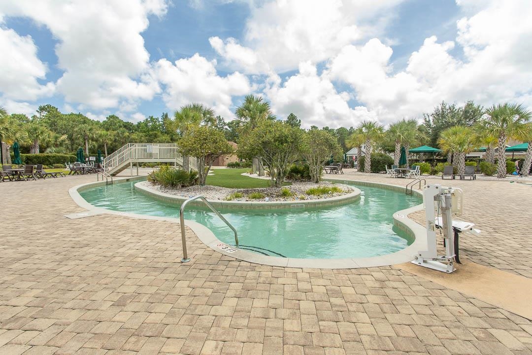 4348 Livorn Loop, Unit 41 Myrtle Beach, SC 29579 - Photo 24 of 30 Community pool with a patio area and view of wooded area