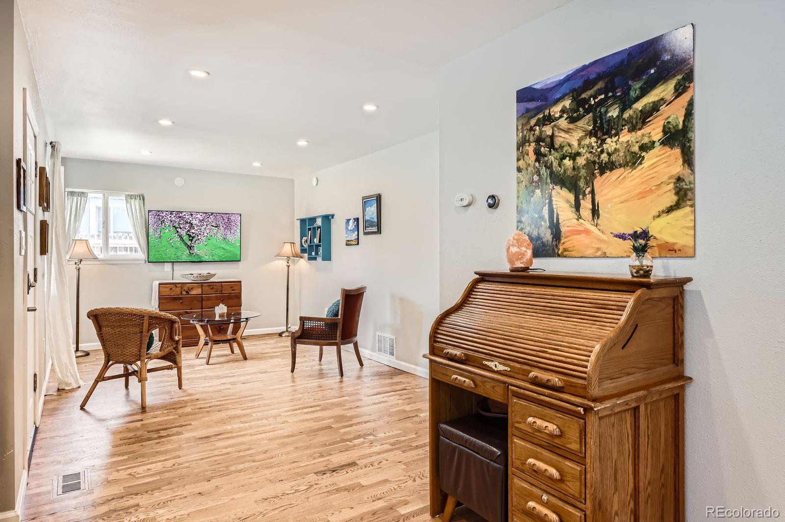 2433 East Monument Street Colorado Springs, CO 80909 - Photo 3 of 11 a view of a dining room with furniture window and wooden floor