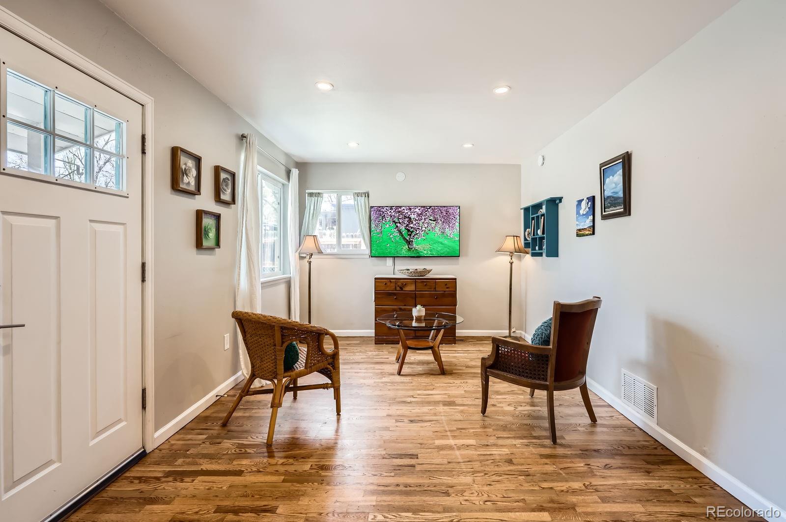 2433 East Monument Street Colorado Springs, CO 80909 - Photo 4 of 11 a living room with furniture and a table