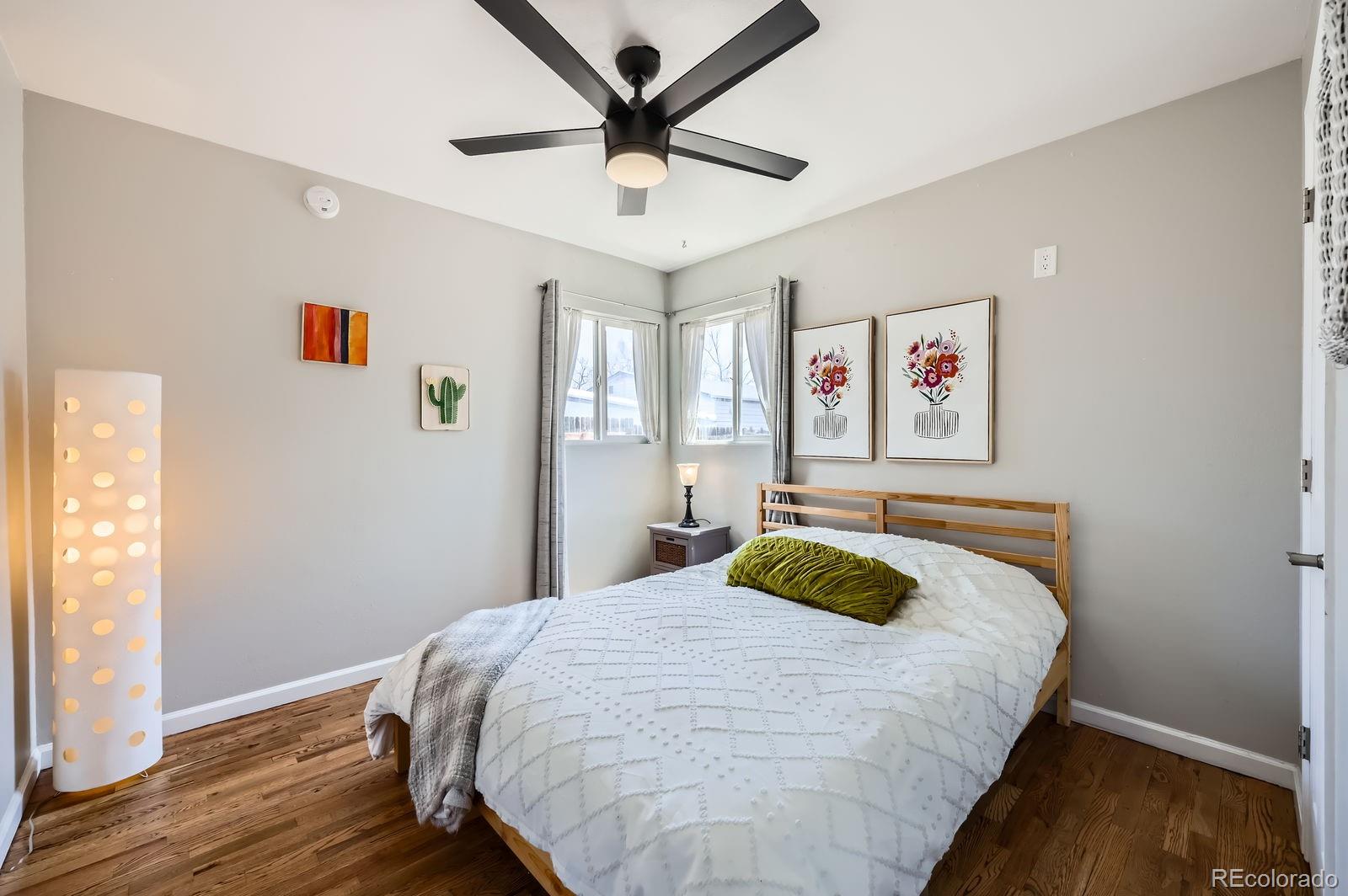 2433 East Monument Street Colorado Springs, CO 80909 - Photo 7 of 11 a bedroom with a bed and wooden floor