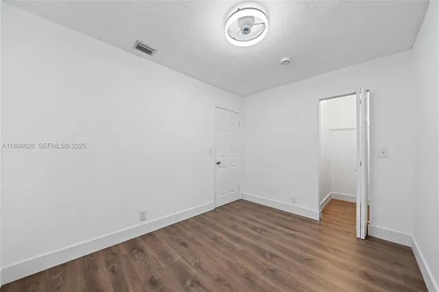 a view of room with wooden floor