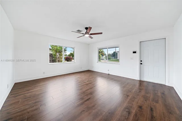 wooden floor in an empty room with a window