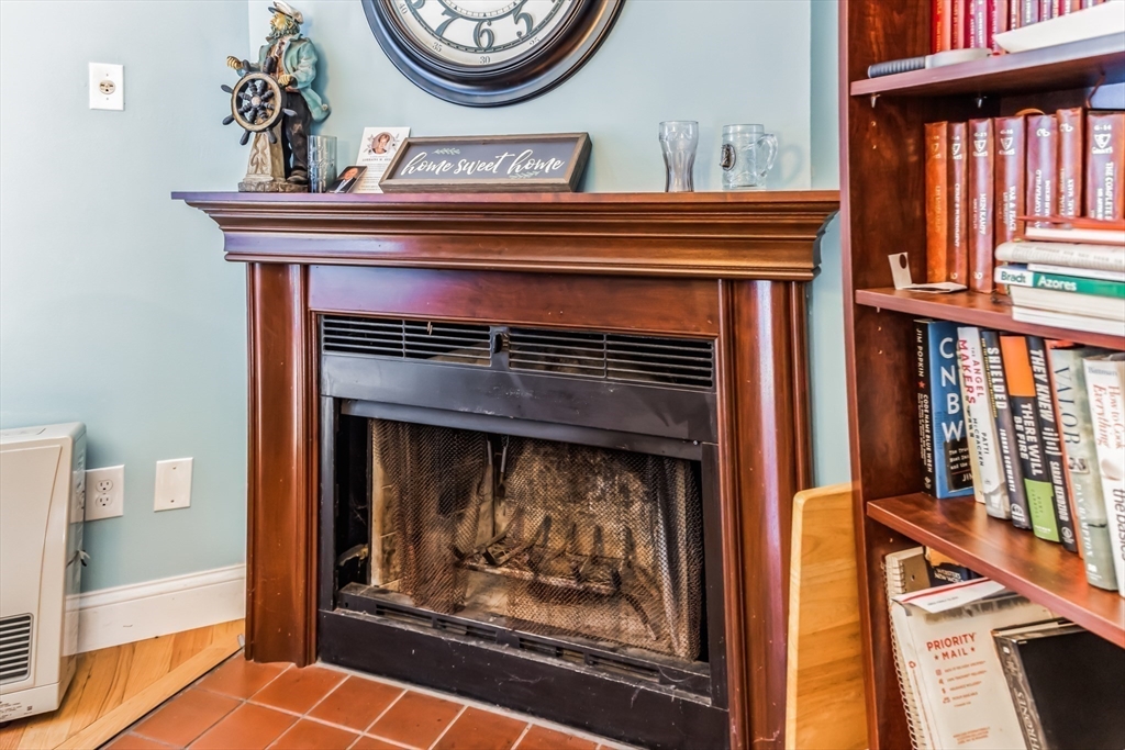 59 Seabury, Unit 59 Hampton, NH 03842 - Photo 11 of 25 a fireplace with a clock on top of it