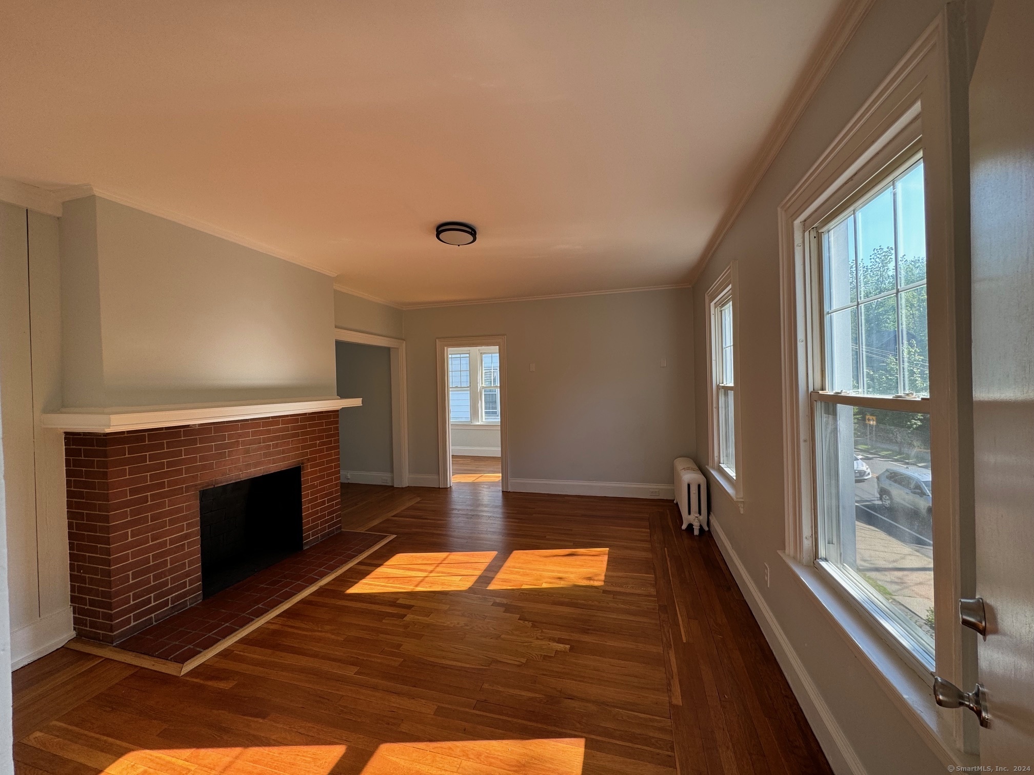 1253 Forest Road, Unit 2 New Haven, CT 06515 - Photo 10 of 30 a room with wooden floor and a fireplace