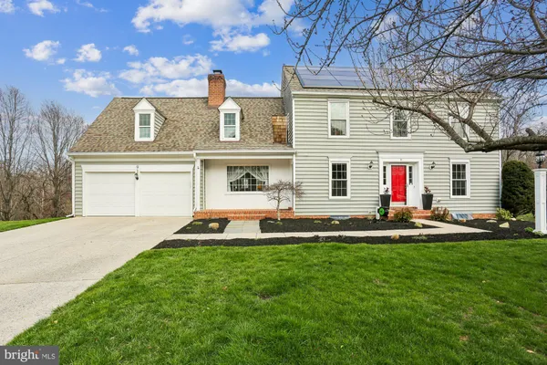 a front view of a house with a garden and plants