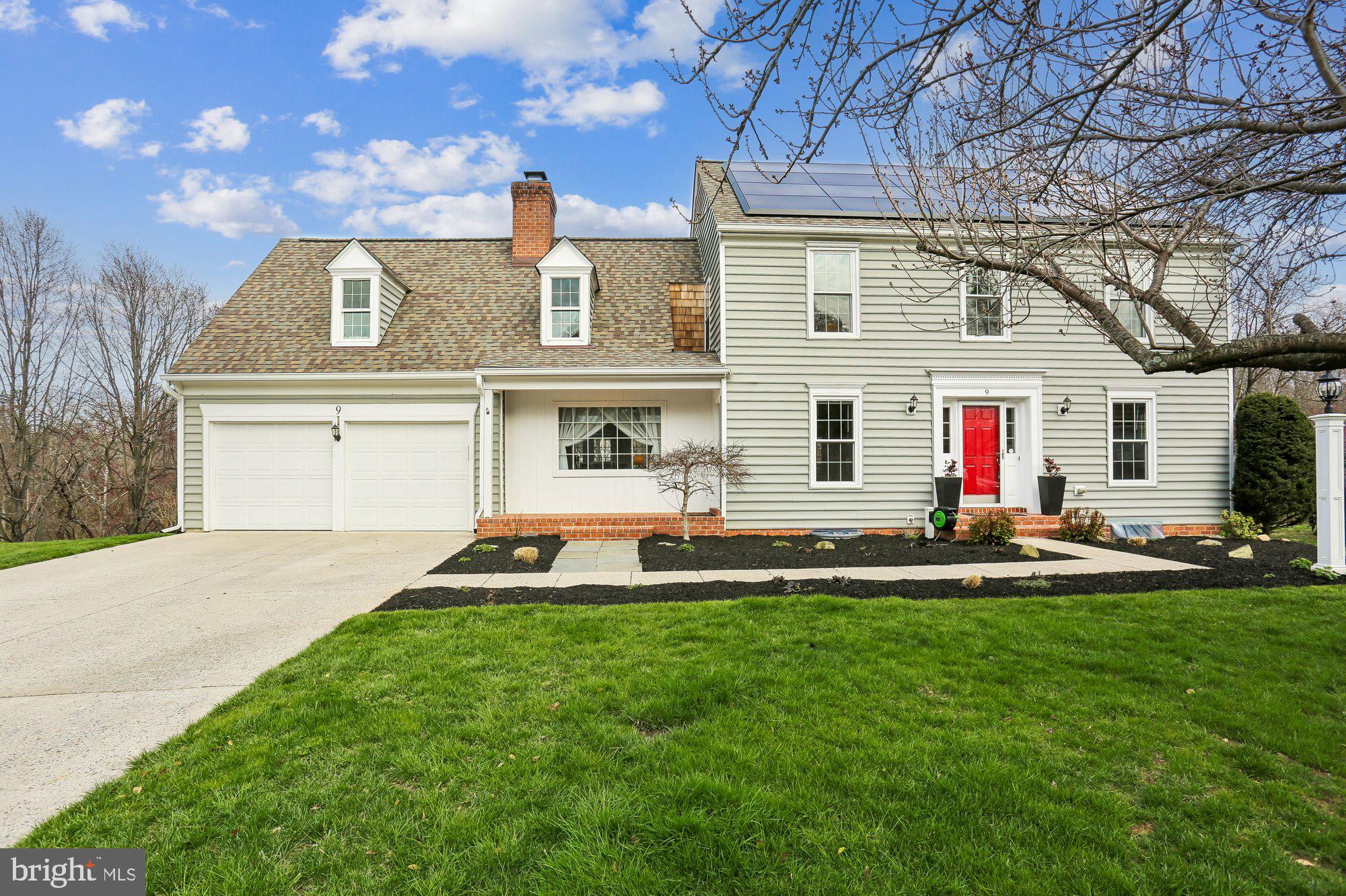 a front view of a house with a garden and plants