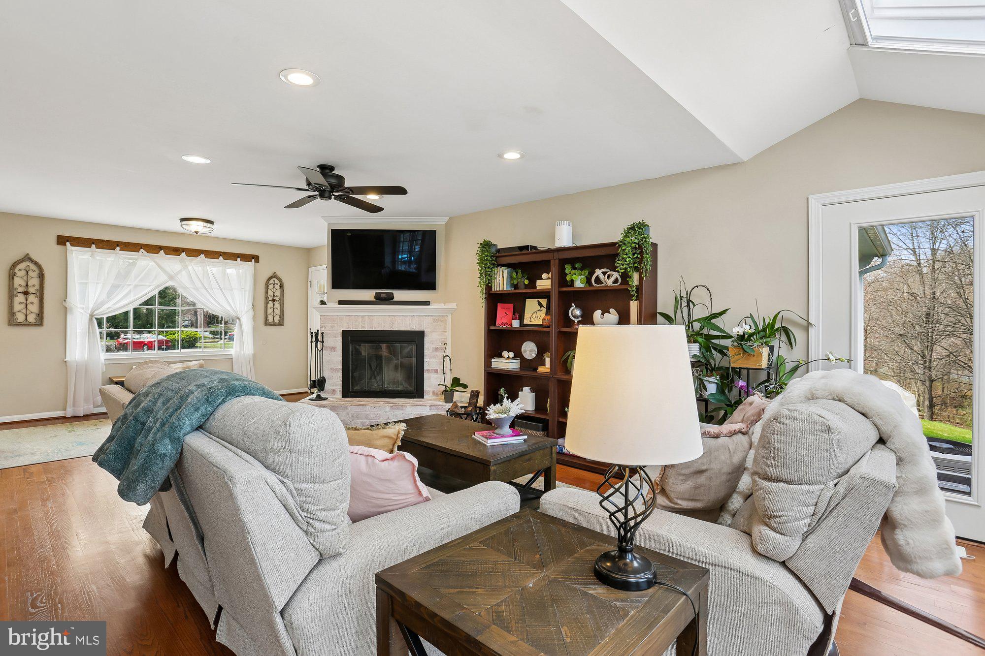 9 Midsummer Court Gaithersburg, MD 20878 - Photo 16 of 69 a living room with furniture a flat screen tv and a fireplace