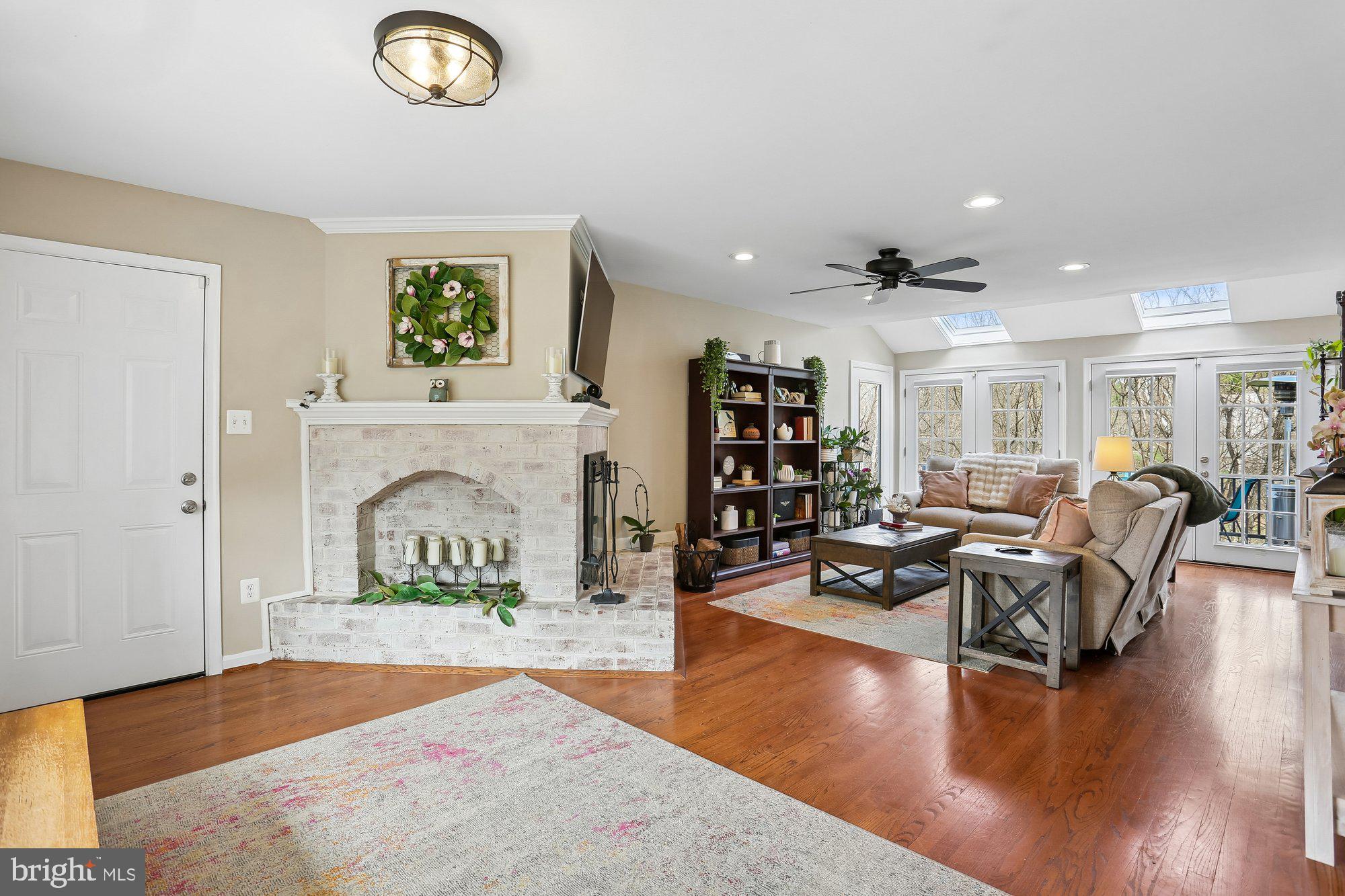 9 Midsummer Court Gaithersburg, MD 20878 - Photo 17 of 69 Family room with double-sided brick fireplace
