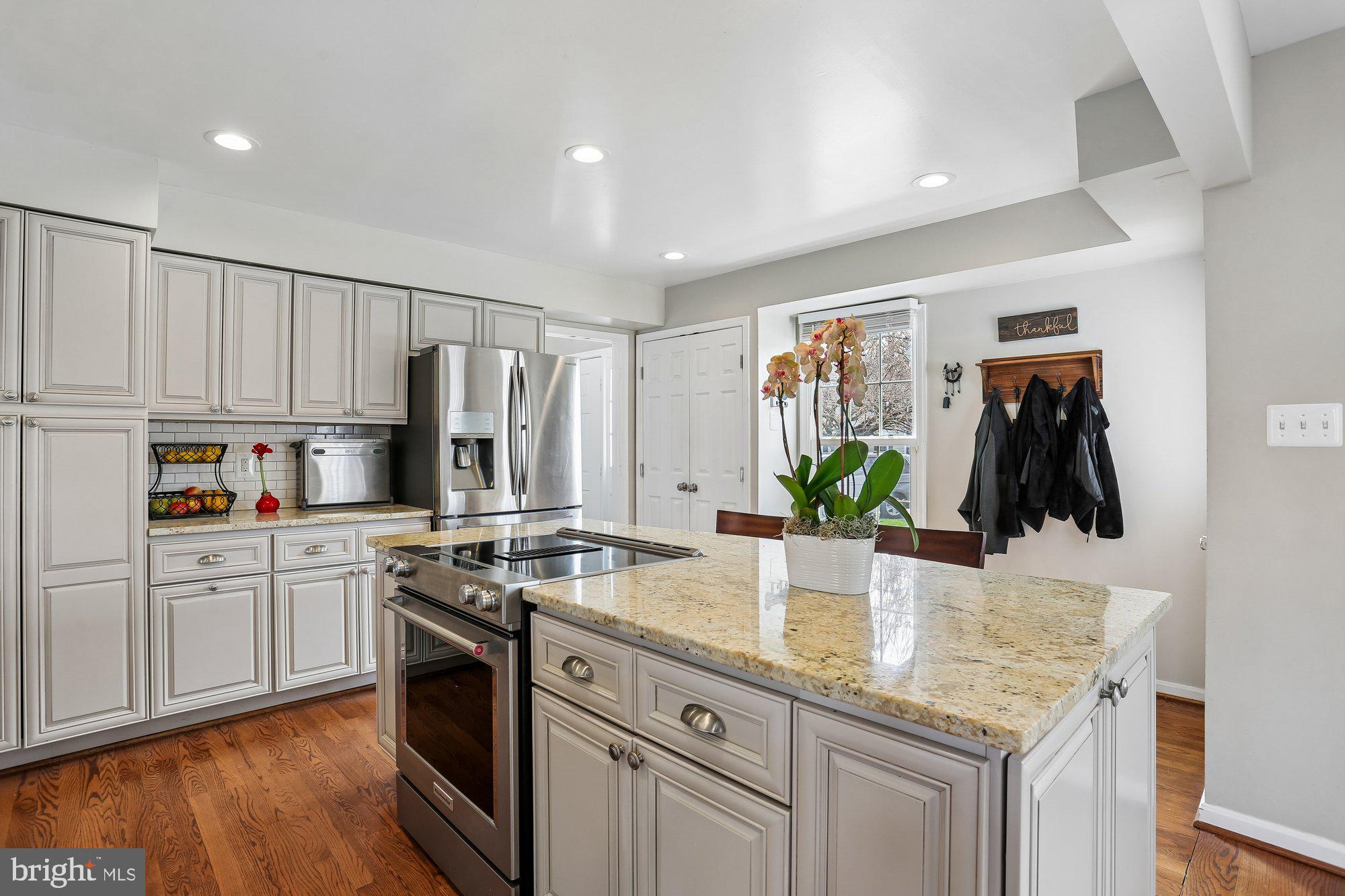 9 Midsummer Court Gaithersburg, MD 20878 - Photo 5 of 69 a kitchen with kitchen island white cabinets and stainless steel appliances