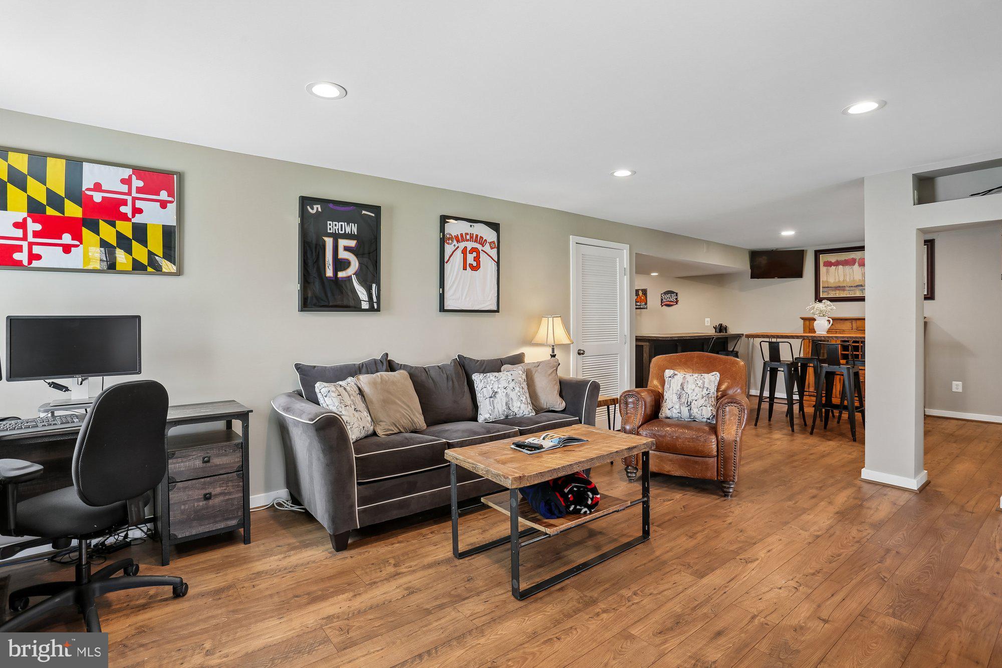 9 Midsummer Court Gaithersburg, MD 20878 - Photo 54 of 69 a living room with furniture a wooden floor and a flat screen tv