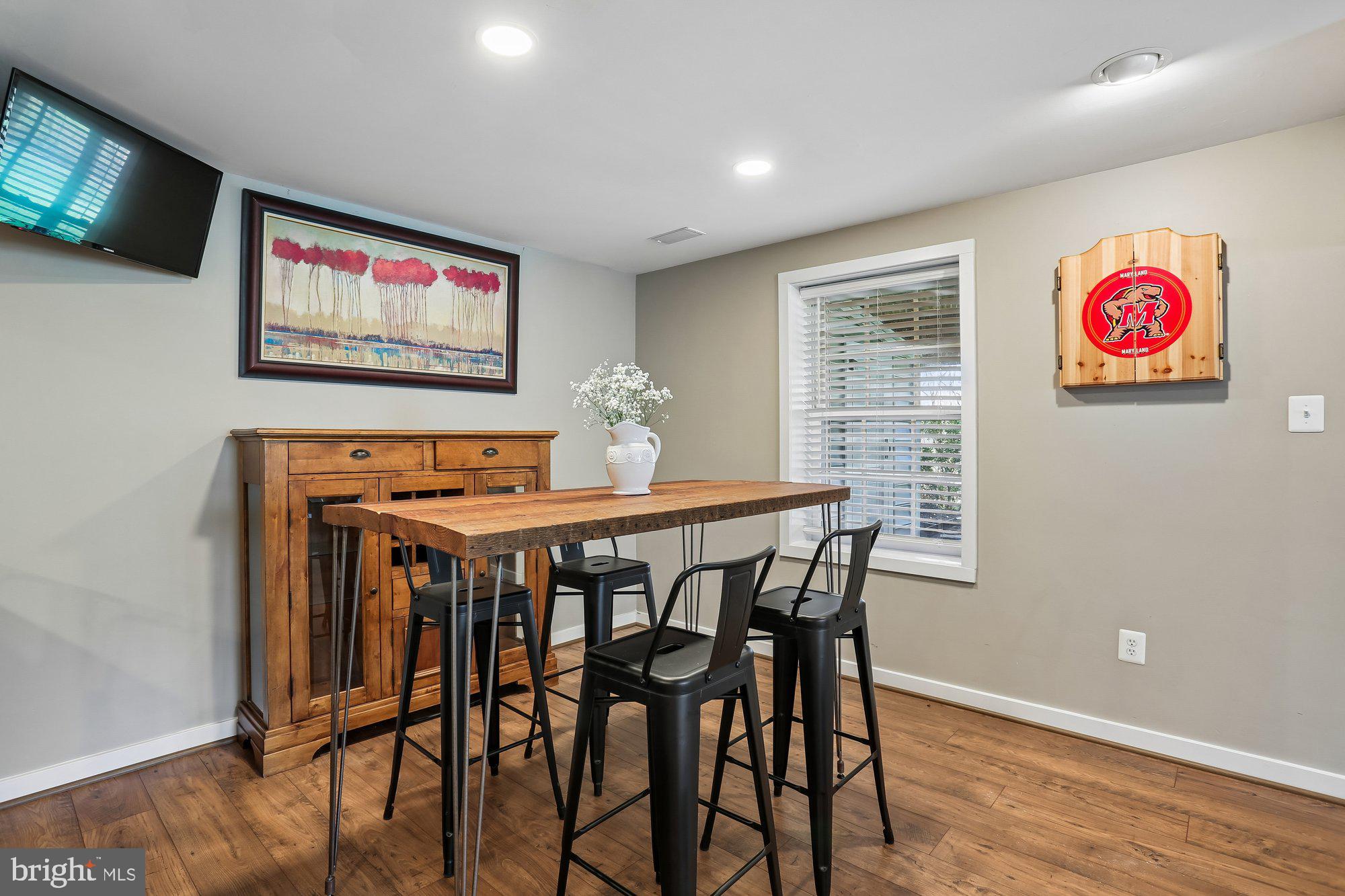 9 Midsummer Court Gaithersburg, MD 20878 - Photo 56 of 69 a view of a dining room with furniture wooden floor and a flat screen tv