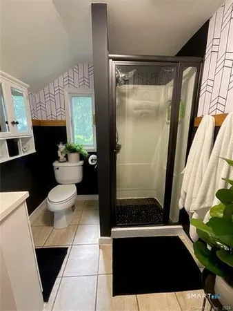 a bathroom with a toilet a sink and a shower