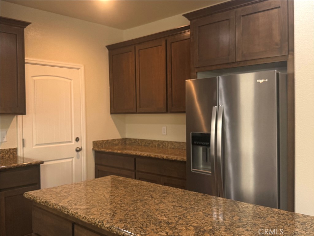 1339 Playa Del Rey Drive Merced, CA 95348 - Photo 7 of 48 a kitchen with stainless steel appliances granite countertop a refrigerator and a sink