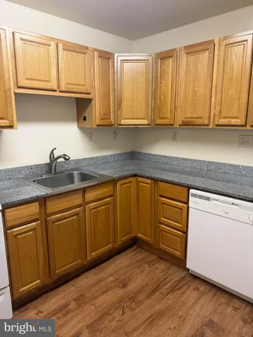 a stove top oven sitting inside of a kitchen