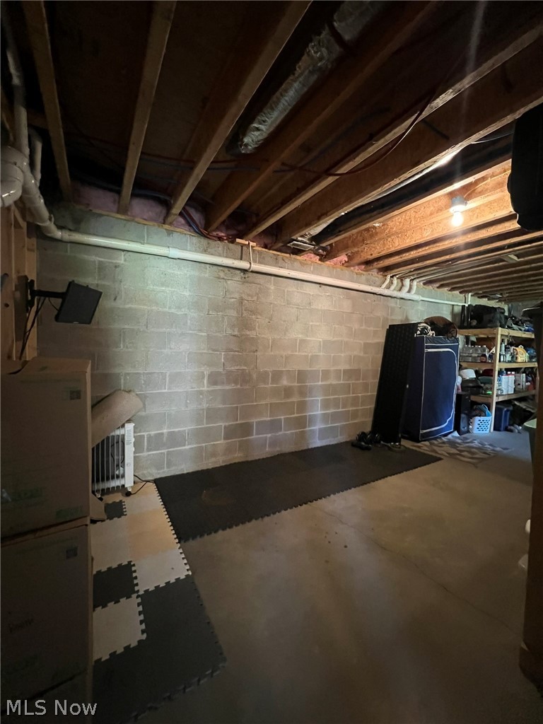 15393 Shade Road Guysville, OH 45735 - Photo 23 of 35 Unfinished basement featuring concrete block walls and exposed ceiling joists
