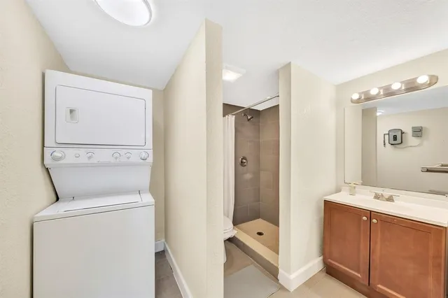 a bathroom with a shower a sink and a mirror