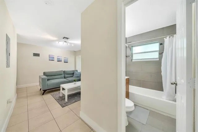 a living room with furniture and a floor to ceiling window